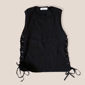 Black knit top with lace up detail.
